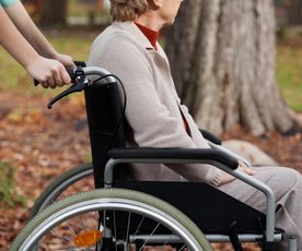 Disabled elder woman on wheelchair with nurse